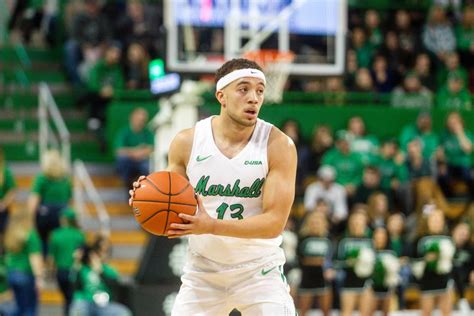 Marshall university men's basketball - Marshall's Nate Martin (41) drives to the basket past Queens' BJ McLaurin during an NCAA men's basketball game against Queens University on Monday at the Cam Henderson Center in Huntington.